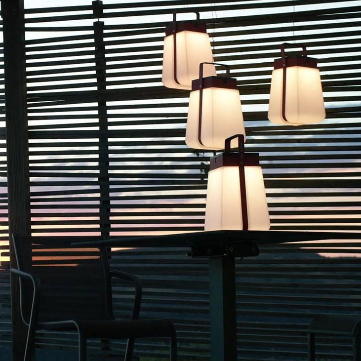 Junam Lights hanging by outdoor seating at dusk